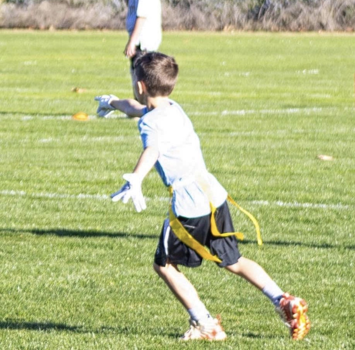 Young RISE player sprinting upfield